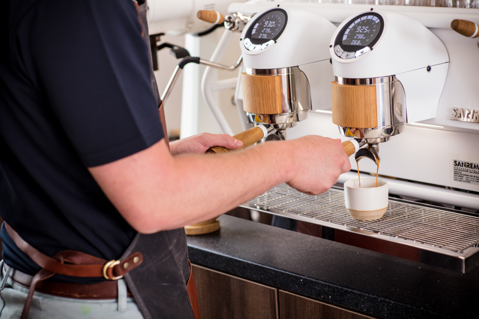 Lifestyle Product Photography of Barista at a Coffee Machine