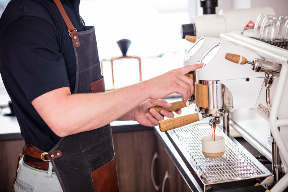 Lifestyle Product Photography of a Barista using a Coffee Machine