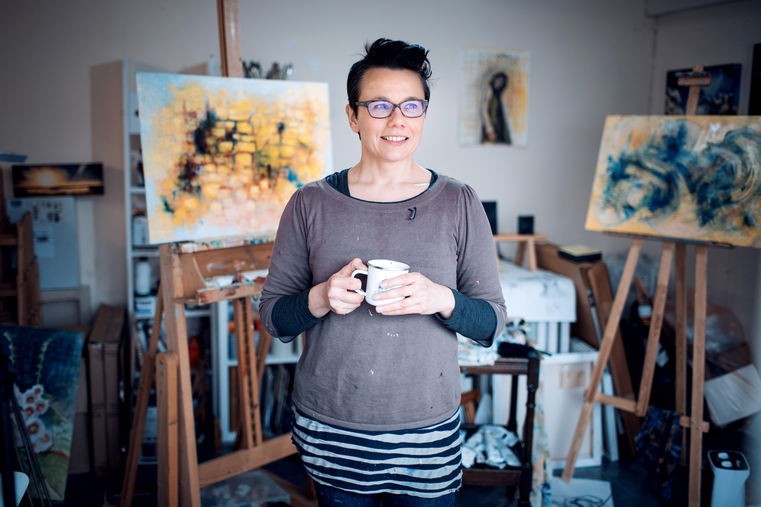 commercial portrait of painter in her studio for photography project